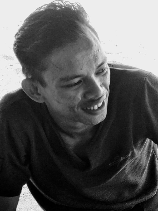 Black-and-white portrait of a laughing man