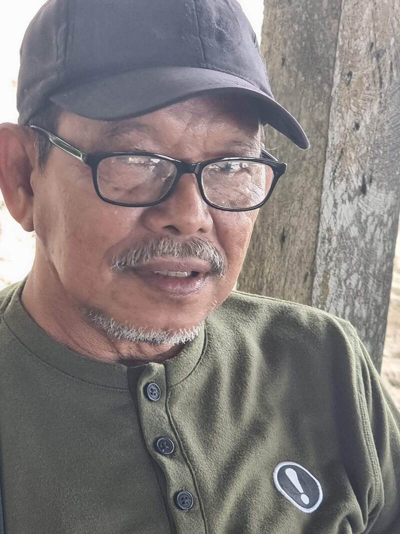 Portrait of a man in glasses and an olive shirt