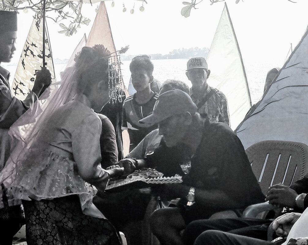 A relaxed group of young people sitting and talking, black and white