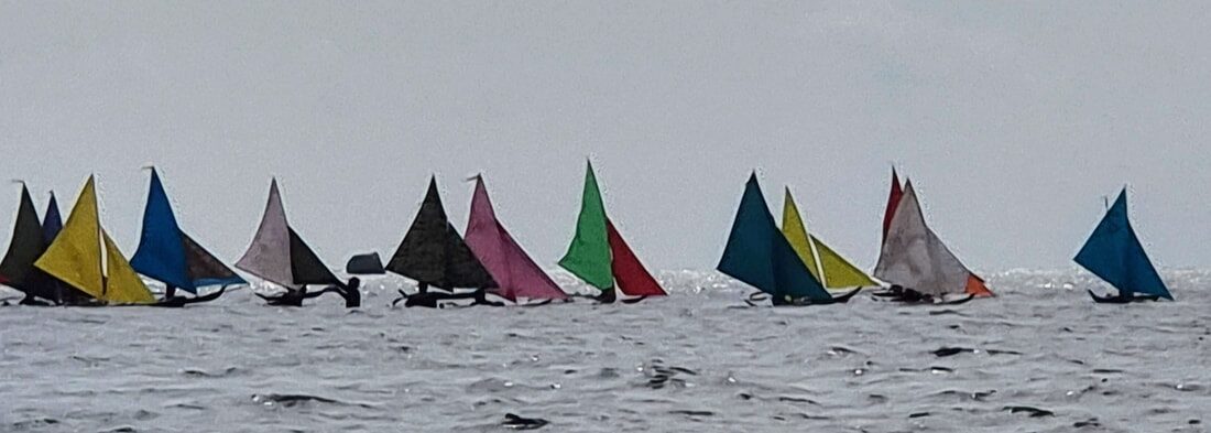 A jong with a striped sail, ready to race