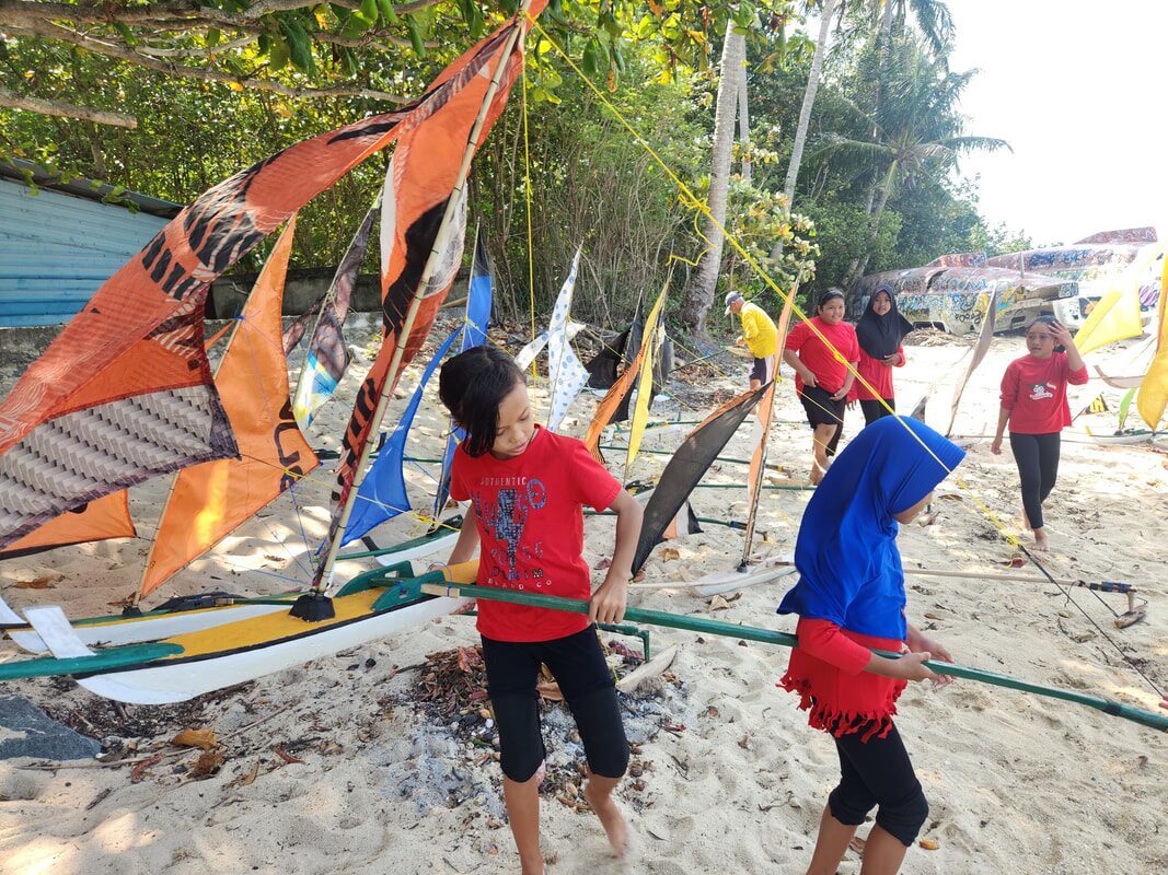 Two people working together to launch a jong into the water