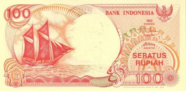 A 1992 Indonesian 100 rupiah banknote featuring a traditional pinisi schooner under red sail